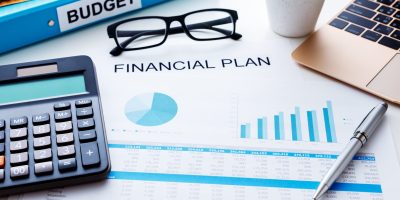 Financial and budget planning concept with calculator laptop and finacial report